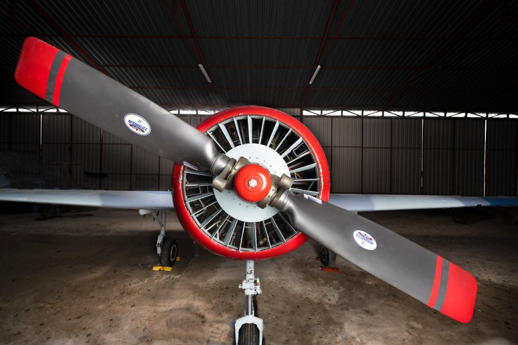 A detailed view of a classic propeller aircraft parked indoors in Madrid.